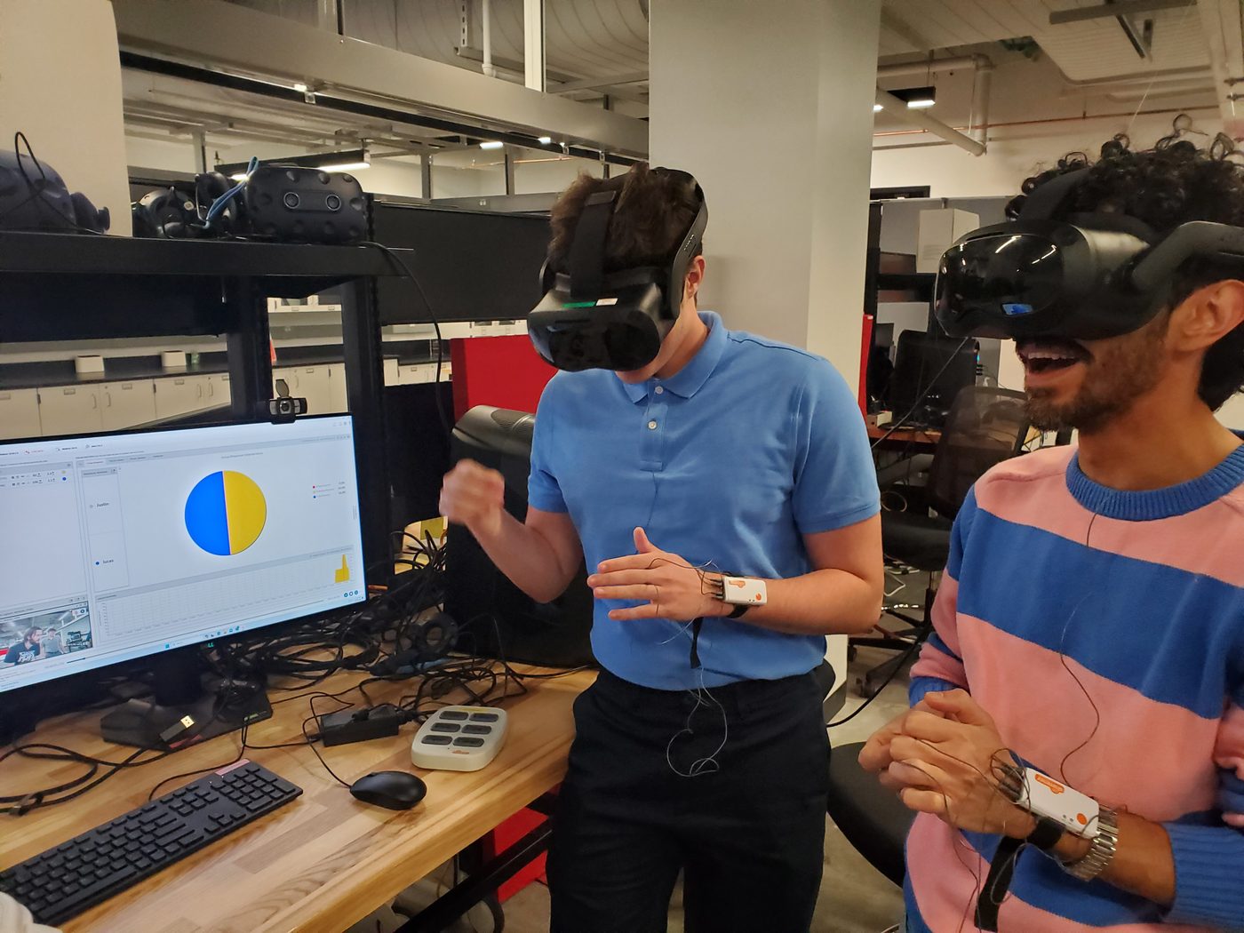 Justin and coworker Sam wearing NeuroLynQ hardware at UCSIM